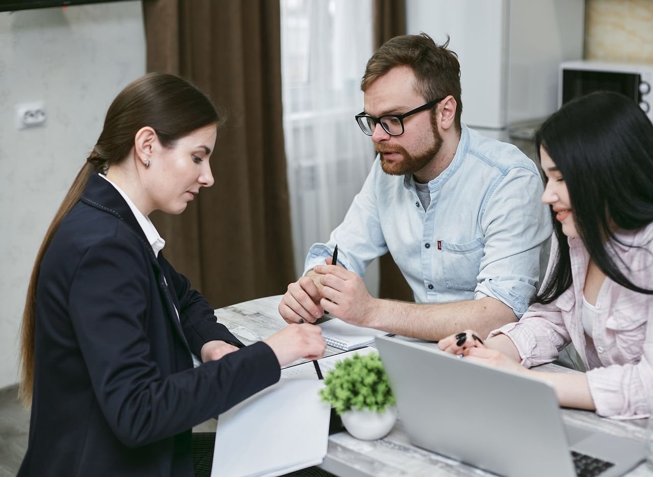 The Art of Drawing Readers In: Your attractive post title goes here A couple discusses financial documents with their advisor, highlighting investment strategies.